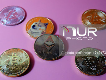 A physical commemorative coin of Bitcoin, Dogecoin, and Ethereum is displayed in Yichang, Hubei province, China, on October 29, 2024. (