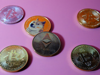 A physical commemorative coin of Bitcoin, Dogecoin, and Ethereum is displayed in Yichang, Hubei province, China, on October 29, 2024. (