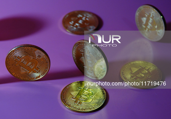 A physical commemorative coin of Bitcoin, Dogecoin, and Ethereum is displayed in Yichang, Hubei province, China, on October 29, 2024. 