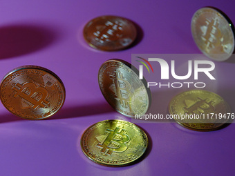 A physical commemorative coin of Bitcoin, Dogecoin, and Ethereum is displayed in Yichang, Hubei province, China, on October 29, 2024. (