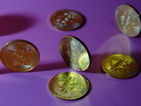 A physical commemorative coin of Bitcoin, Dogecoin, and Ethereum is displayed in Yichang, Hubei province, China, on October 29, 2024. (