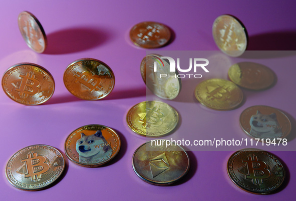 A physical commemorative coin of Bitcoin, Dogecoin, and Ethereum is displayed in Yichang, Hubei province, China, on October 29, 2024. 