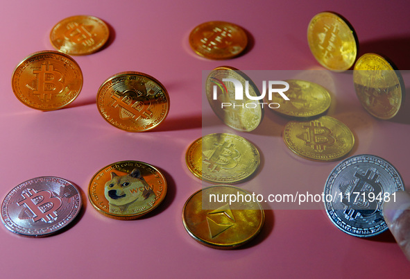 A physical commemorative coin of Bitcoin, Dogecoin, and Ethereum is displayed in Yichang, Hubei province, China, on October 29, 2024. 