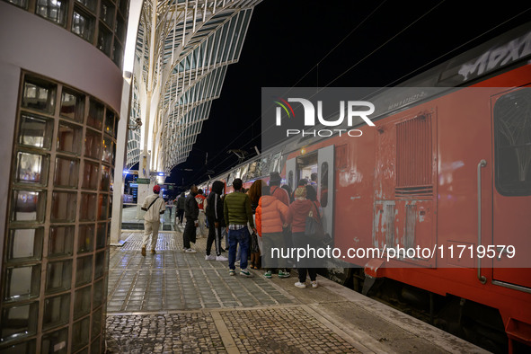 People board a train on one of the platforms at Oriente railway station in Lisbon, Portugal, on October 28, 2024. Due to a growing shortfall...