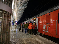 People board a train on one of the platforms at Oriente railway station in Lisbon, Portugal, on October 28, 2024. Due to a growing shortfall...