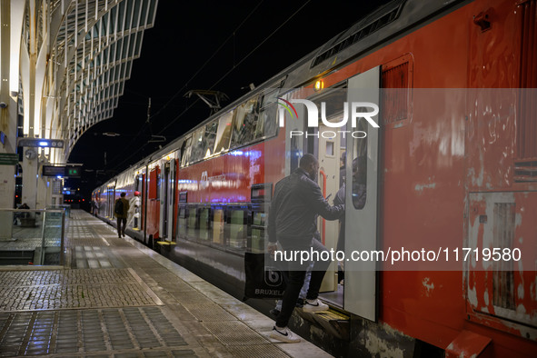 People board a train on one of the platforms at Oriente railway station in Lisbon, Portugal, on October 28, 2024. Due to a growing shortfall...