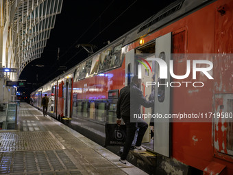 People board a train on one of the platforms at Oriente railway station in Lisbon, Portugal, on October 28, 2024. Due to a growing shortfall...