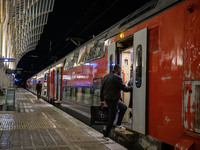 People board a train on one of the platforms at Oriente railway station in Lisbon, Portugal, on October 28, 2024. Due to a growing shortfall...