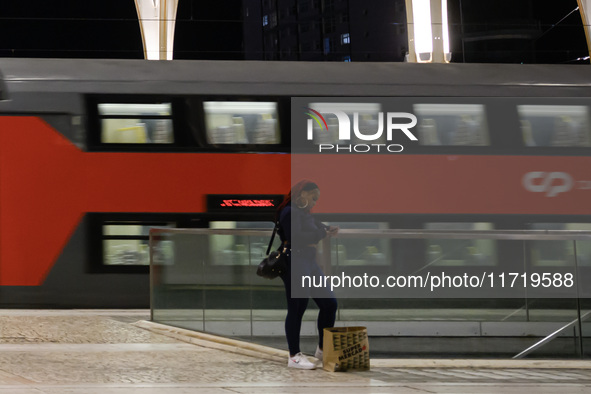 A person stands waiting for the arrival of a train on a platform at Oriente railway station in Lisbon, Portugal, on October 28, 2024. Due to...