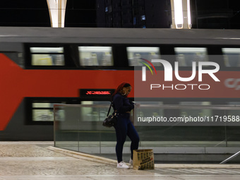 A person stands waiting for the arrival of a train on a platform at Oriente railway station in Lisbon, Portugal, on October 28, 2024. Due to...