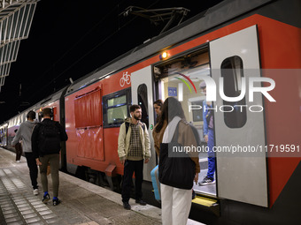 People board a train on one of the platforms at Oriente railway station in Lisbon, Portugal, on October 28, 2024. Due to a growing shortfall...