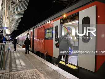 People board a train on one of the platforms at Oriente railway station in Lisbon, Portugal, on October 28, 2024. Due to a growing shortfall...