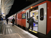 People board a train on one of the platforms at Oriente railway station in Lisbon, Portugal, on October 28, 2024. Due to a growing shortfall...