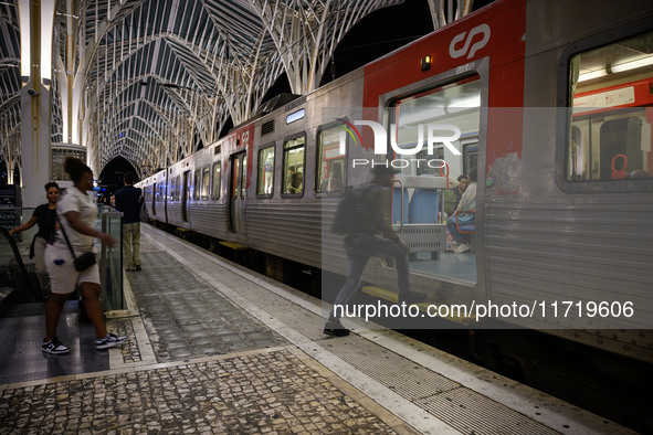 People board a train on one of the platforms at Oriente railway station in Lisbon, Portugal, on October 28, 2024. Due to a growing shortfall...