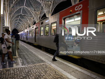 People board a train on one of the platforms at Oriente railway station in Lisbon, Portugal, on October 28, 2024. Due to a growing shortfall...