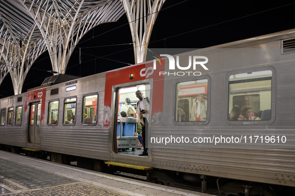 A person stands at the entrance of a train carriage waiting for departure at Oriente railway station in Lisbon, Portugal, on October 28, 202...