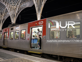 A person stands at the entrance of a train carriage waiting for departure at Oriente railway station in Lisbon, Portugal, on October 28, 202...