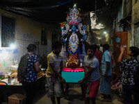 An idol of Goddess Kali is carried to pandals ahead of the Kali Puja and Diwali festival in Kolkata, India, on October 29, 2024. (