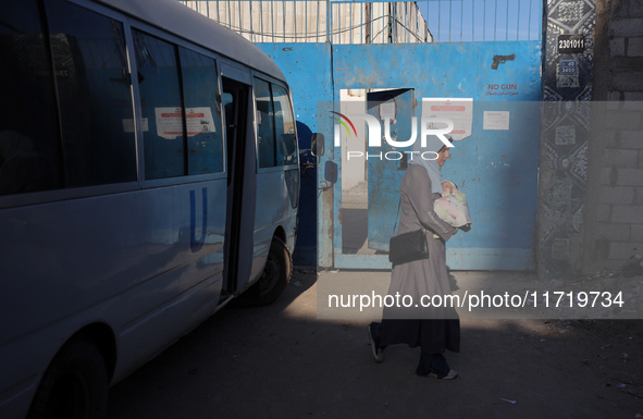 UN employees enter the United Nations Relief and Works Agency for Palestine Refugees (UNRWA) center in the Nuseirat refugee camp in central...