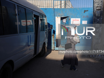 UN employees enter the United Nations Relief and Works Agency for Palestine Refugees (UNRWA) center in the Nuseirat refugee camp in central...