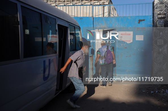 UN employees enter the United Nations Relief and Works Agency for Palestine Refugees (UNRWA) center in the Nuseirat refugee camp in central...