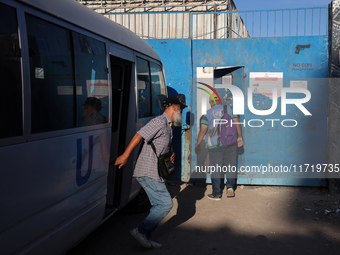 UN employees enter the United Nations Relief and Works Agency for Palestine Refugees (UNRWA) center in the Nuseirat refugee camp in central...