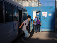 UN employees enter the United Nations Relief and Works Agency for Palestine Refugees (UNRWA) center in the Nuseirat refugee camp in central...