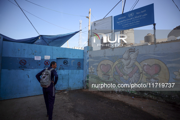 UN employees enter the United Nations Relief and Works Agency for Palestine Refugees (UNRWA) center in the Nuseirat refugee camp in central...