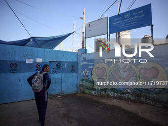 UN employees enter the United Nations Relief and Works Agency for Palestine Refugees (UNRWA) center in the Nuseirat refugee camp in central...