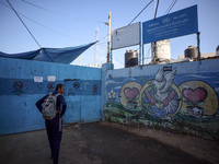 UN employees enter the United Nations Relief and Works Agency for Palestine Refugees (UNRWA) center in the Nuseirat refugee camp in central...