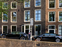 Two electric cars charge at a station located along a canal in central Amsterdam, Netherlands, on July 8, 2019. (