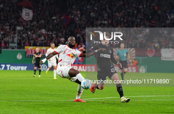 El Chadaille Bitshiabu of Leipzig controls the ball during the DFB Cup  Second Round match between RB Leipzig and FC St. Pauli at Red Bull a...