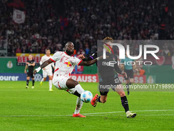 El Chadaille Bitshiabu of Leipzig controls the ball during the DFB Cup  Second Round match between RB Leipzig and FC St. Pauli at Red Bull a...