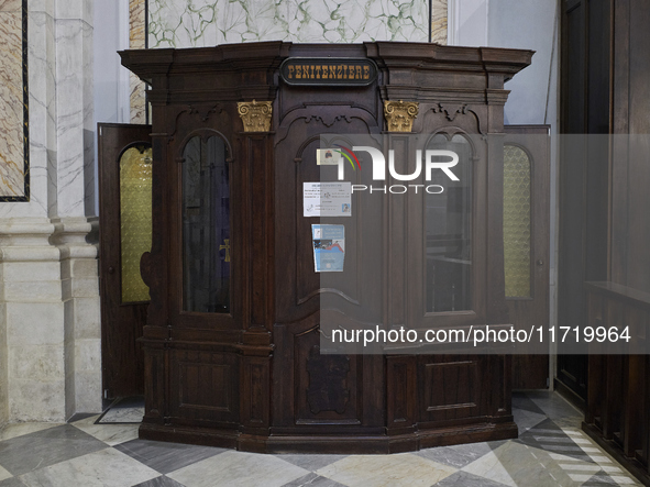 A detailed view of a traditional confessional inside the Cathedral of Foggia in Foggia, Italy, on March 12, 2024. This image captures the so...