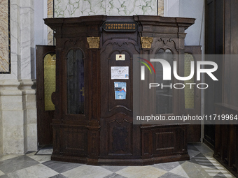 A detailed view of a traditional confessional inside the Cathedral of Foggia in Foggia, Italy, on March 12, 2024. This image captures the so...