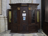 A detailed view of a traditional confessional inside the Cathedral of Foggia in Foggia, Italy, on March 12, 2024. This image captures the so...