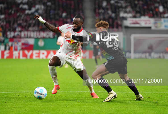 El Chadaille Bitshiabu of Leipzig controls the ball during the DFB Cup  Second Round match between RB Leipzig and FC St. Pauli at Red Bull a...