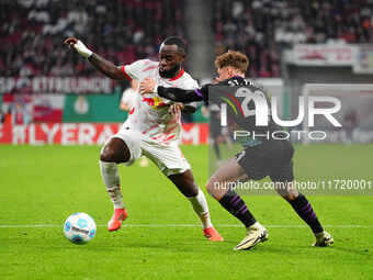 El Chadaille Bitshiabu of Leipzig controls the ball during the DFB Cup  Second Round match between RB Leipzig and FC St. Pauli at Red Bull a...