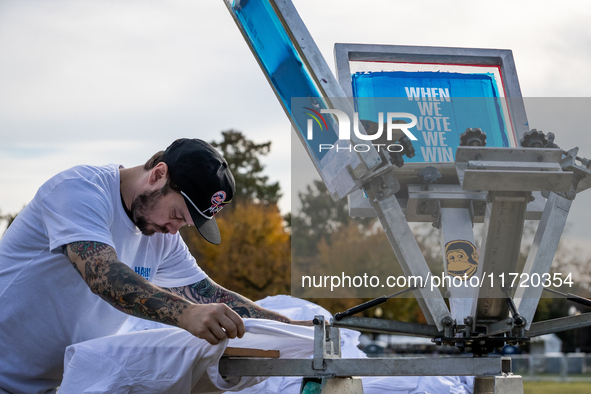 A volunteer prints t-shirts on site at a rally where Vice President Kamala Harris will deliver what her campaign has billed as a “closing ar...