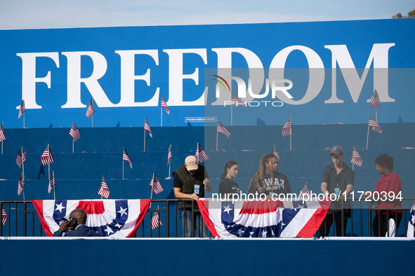 Volunteers put the final touch on stage decorations for a rally in which Vice President Kamala Harris delivers what her campaign has billed...