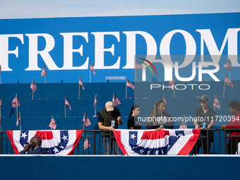 Volunteers put the final touch on stage decorations for a rally in which Vice President Kamala Harris delivers what her campaign has billed...