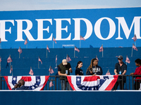 Volunteers put the final touch on stage decorations for a rally in which Vice President Kamala Harris delivers what her campaign has billed...