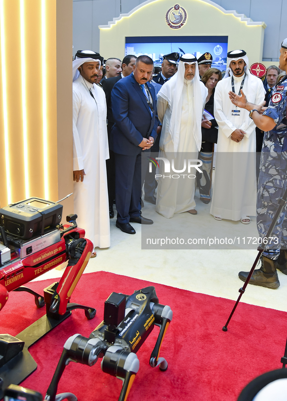 Sheikh Khalifa bin Hamad bin Khalifa Al Thani, Qatar Minister of Interior, looks at smart communication systems after the opening ceremony o...