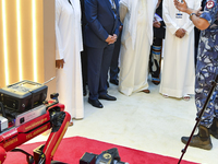 Sheikh Khalifa bin Hamad bin Khalifa Al Thani, Qatar Minister of Interior, looks at smart communication systems after the opening ceremony o...