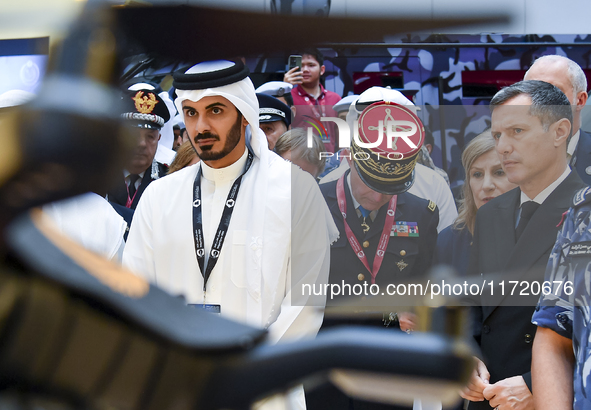 Sheikh Khalifa bin Hamad bin Khalifa Al Thani, Qatar's Minister of Interior, looks at smart communication systems after the opening ceremony...