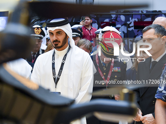 Sheikh Khalifa bin Hamad bin Khalifa Al Thani, Qatar's Minister of Interior, looks at smart communication systems after the opening ceremony...