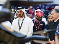 Sheikh Khalifa bin Hamad bin Khalifa Al Thani, Qatar's Minister of Interior, looks at smart communication systems after the opening ceremony...