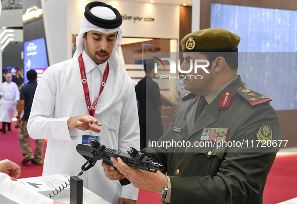 A visiting Kuwait defense official inspects a weapon after the opening ceremony of the 15th edition of the Milipol Qatar 2024 Exhibition and...