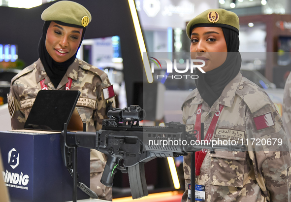 Two women officers from the Qatar Ministry of Defence attend the 15th edition of the Milipol Qatar 2024 Exhibition and Conference in Doha, Q...