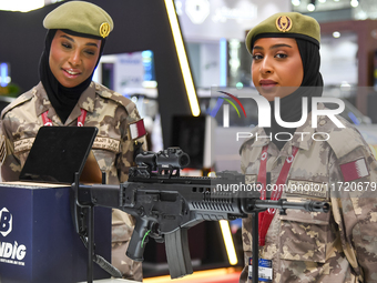 Two women officers from the Qatar Ministry of Defence attend the 15th edition of the Milipol Qatar 2024 Exhibition and Conference in Doha, Q...